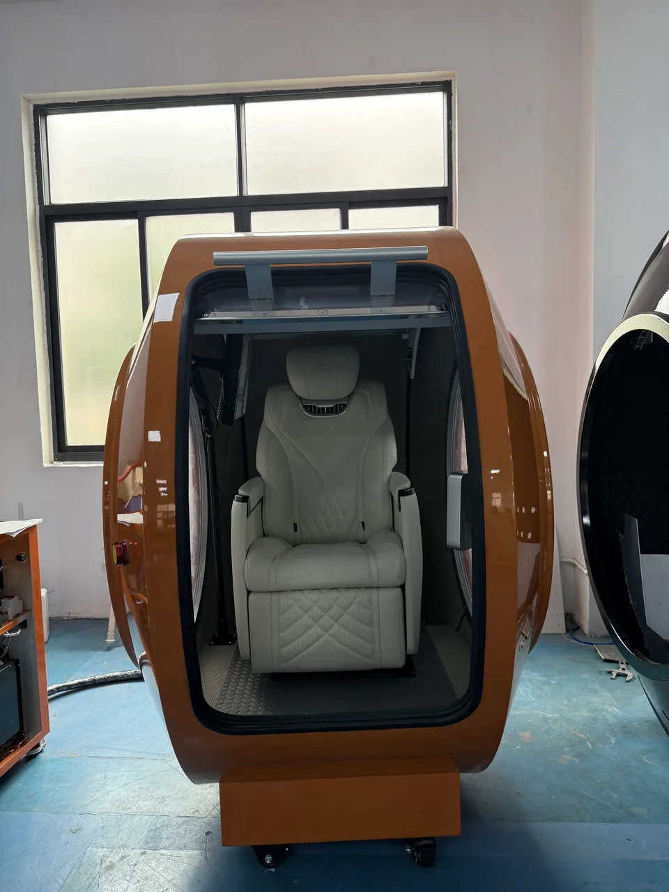Orange VISTA, door open, with a single seat